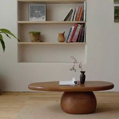 a wooden table sitting in front of a book shelf