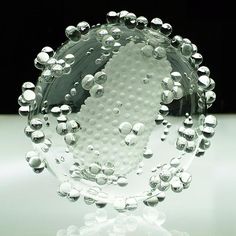 an image of a glass object with bubbles on it's face and in the center