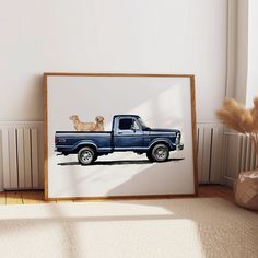 a blue pickup truck with two dogs on the bed is shown in front of a white wall