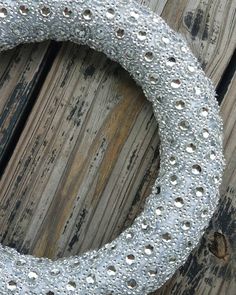 a close up of a metal ring on a wooden surface