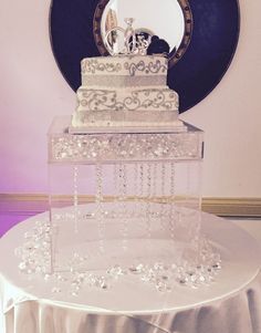 a three tiered wedding cake sitting on top of a table