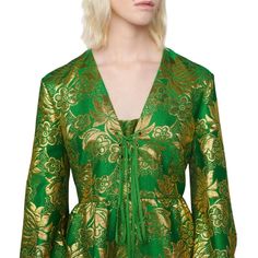 Green and gold floral patterned wool is punctuated by lamé detail on this front tie gown. Rich in pattern and decorationGreen and gold wool lamé floral jacquardLace detailDue to the printing technique used, the placement of the pattern will vary from item to itemFront tie detailPuff sleevesBack zip closureColour: Green and GoldComposition: 71% wool 15% metallic polyester and 14% polyamideDry cleanMade in Italy Gucci Silk Dress For Wedding, Gucci Silk Wedding Dress, Gucci Silk Dress For Gala, Formal Gold Jacquard Dress, Fitted Gucci Floral Print Dresses, Gucci Silk Long Sleeve Dress, Long Sleeve Gucci Dresses For Fall, Gucci Long Sleeve Silk Dress, Gold Jacquard Party Dress