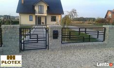 a large house with a gate in front of it and a driveway leading to the entrance