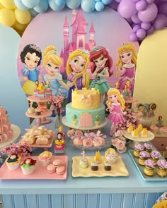 there is a cake and cupcakes on the table at this princess birthday party