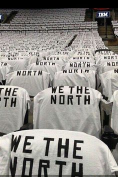 we the north t - shirts are lined up in an empty bleachers with words on them