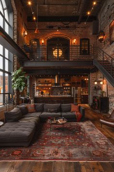 a living room with couches, tables and stairs leading to the second floor area