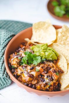 a bowl filled with chili and tortilla chips