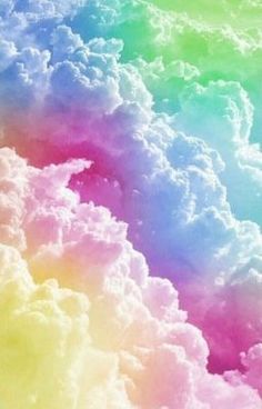 the sky is full of clouds and rainbow colors