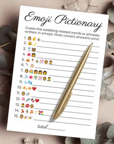 a notepad with emoj dictionary written on it next to some flowers and leaves