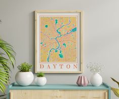 a framed map of the city of daytona, florida on a wall above a dresser