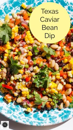 a blue and white plate topped with corn salad