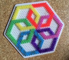 a white plate topped with lots of colorful beads