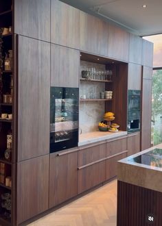 a kitchen with wooden cabinets and shelves filled with food