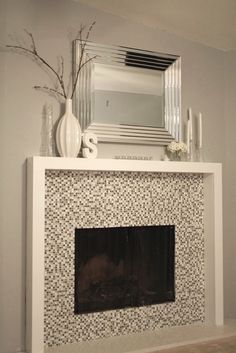 a white fireplace with a mirror above it