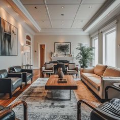 a living room filled with lots of furniture next to a large painting on the wall