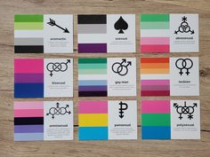 six cards with different symbols on them sitting next to each other in front of a wooden table