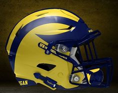 a football helmet is shown with the word michigan in blue and yellow on it's side