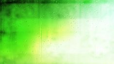 raindrops on the window with green and yellow blurry in the back ground