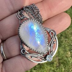 "This beautiful, detailed moon pendant has been handcrafted from 935 silver and sterling silver. The main stone is a stunning rainbow moonstone, with is paired Aquamarine. The pendant was carefully oxidized and polished to give it an antique look. Pendant: Length and width: 1.88\"x1.37\" inches (48x35mm) Materials: 925 sterling silver, 935 silver Gemstones: Rainbow Moonstone 31x20mm - 31.45ct, Aquamarine 5mm Necklace: Length: 18\"+1.18\", 20\"+1.18\" or 24\"+1.18\"  Extension chain: 1.37\"  Mate Oxidized Moonstone Pendant Necklace, Moonstone Pendant Necklace With Oxidized Finish, Artisan Silver Necklace With Moon Phase, Artisan Silver Necklace With Moon Phase Detail, Artisan Silver Jewelry With Moon Phase, Silver Oxidized Moonstone Necklace, Artisan Moonstone Moon-shaped Jewelry, Necklace Extension, Crescent Moon Necklace Silver