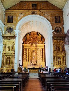 the inside of a church with pews and gold decorations on the alter, walls and ceiling