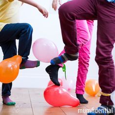 two children playing with balloons on the floor