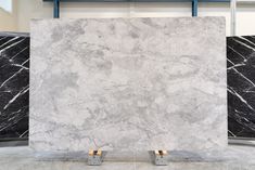 marble is displayed in the middle of a room with two metal racks on each side