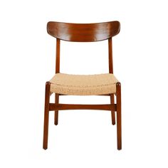 a wooden chair with a woven seat pad on it's back end and side