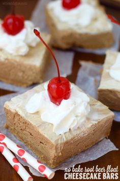 there are four pieces of cake with whipped cream and cherries on top, sitting on paper napkins