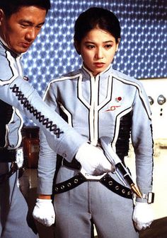 two people standing next to each other in space suits