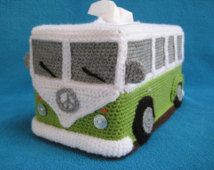 a green and white crocheted bus tissue box on a blue background with a towel