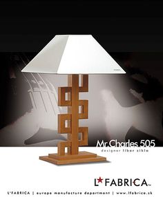 the lamp is made out of wood and has a white shade on it's base