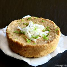 a close up of a sandwich on a paper towel with green onions and mayonnaise