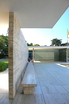 a person sitting on a bench in front of a building