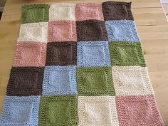 a crocheted blanket sitting on top of a wooden table