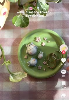 a green plate topped with lots of different types of jewelry on top of a table