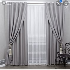 the curtains are open and ready for us to see in this room with grey walls