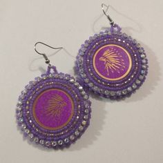 Hand made beaded earrings.  Colors: Purple & Gold Closure: Hook size: 2 inches Adjustable Large Beaded Earrings, Beaded Earrings As A Gift, Colorful Beaded Adjustable Earrings As Gift, Festive Beaded Hoop Earrings With Round Beads, Festive Beaded Hoop Earrings, Adjustable Colorful Beaded Earrings As Gift, Adjustable Colorful Beaded Earrings For Gifts, Adjustable Round Beaded Earrings For Festive Occasions, Festive Round Beaded Earrings