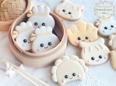 decorated cookies in the shape of bears are sitting on a table with chopsticks