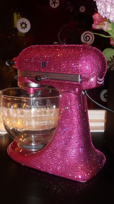 a pink mixer sitting on top of a table