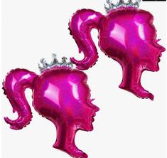 two pink balloons shaped like heads with crowns on their heads, one is wearing a tiara