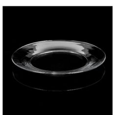 an empty glass plate on a black background