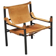 a brown leather chair with black metal legs and a wooden seat that is folded down