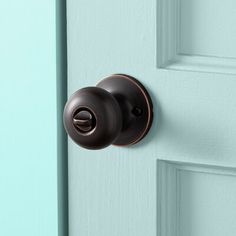 a close up of a door handle on a blue door