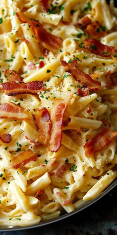 a plate full of pasta with bacon and parsley