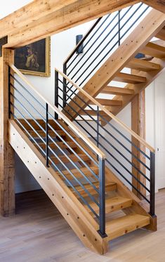 a wooden staircase with metal handrails in a home