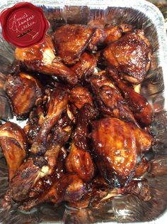 chicken wings covered in bbq sauce sitting on top of foil