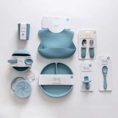 a table set with blue dishes and utensils