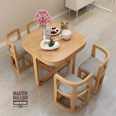 a wooden table with four chairs around it