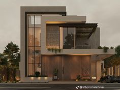 a large modern house with lots of windows and plants on the front porch, along with cars parked outside