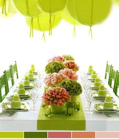 the table is set up for a party with green and pink flowers in vases